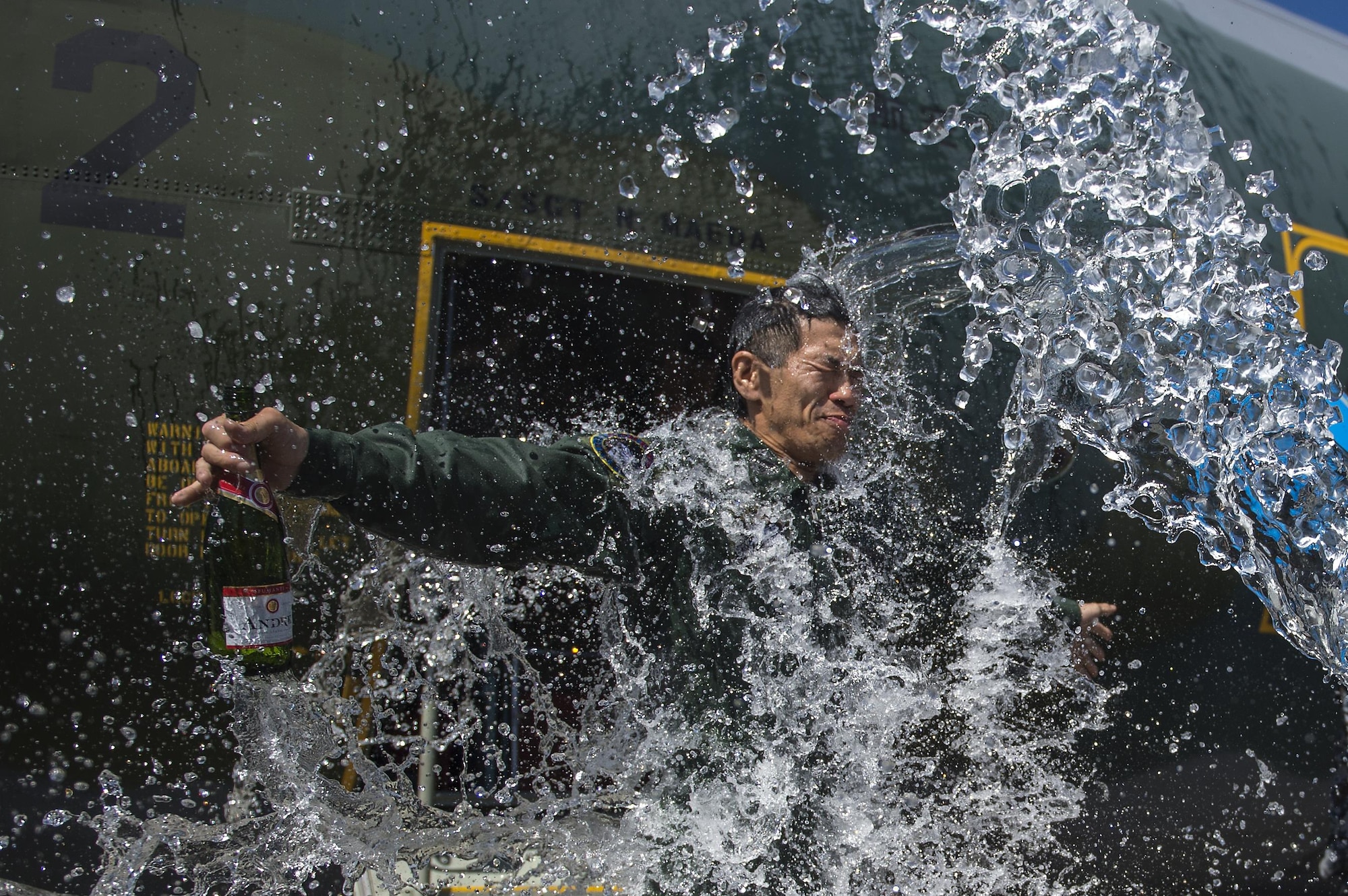 Japanese Air Self Defense Force Chief Master Sgt. Takanori Konishi, with the 401st Squadron, 1st Tactical Airlift Wing in Japan celebrates after completing the milestone of 10,000 C-130 Hercules flight hours on June 15, 2016, at Joint Base Elmendorf-Richardson, Alaska. A rare milestone, Konishi has spent a little over 416 days flying in the C-130. U.S. Air Force photo by Senior Airman James Richardson