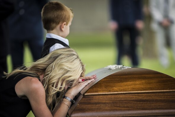 Family members of Lt. Col. William “Bill” Schroeder pay their final respects during his interment ceremony June 16, 2016, at Arlington National Cemetery, Va. Schroeder, 39, was a special operations weather officer who identified a perilous situation and reacted swiftly by putting himself between an armed individual and his first sergeant. In the process, he saved lives of other squadron members while being fatally wounded. (U.S. Air Force photo/Airman 1st Class Philip Bryant)