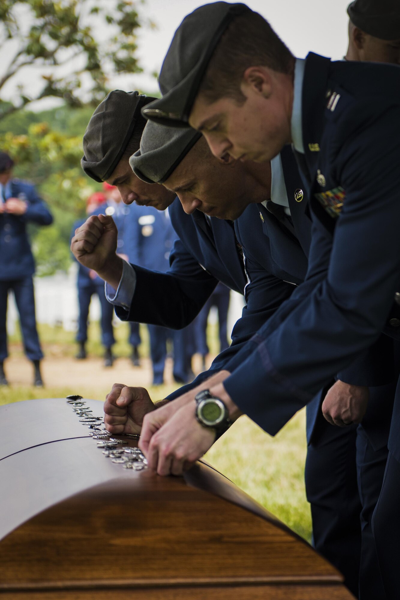 U.S. Air Force Special Operations Weather Team members pound their career badge – or flash – into the casket of Lt. Col. William “Bill” Schroeder, during his interment ceremony, June 16, 2016, at Arlington National Cemetery, Virginia. Schroeder, 39, was a special operations weather officer who identified a perilous situation and reacted swiftly by putting himself between an armed individual and his first sergeant. In the process, he saved lives of other squadron members while being fatally wounded. (U.S. Air Force photo by Airman 1st Class Philip Bryant)