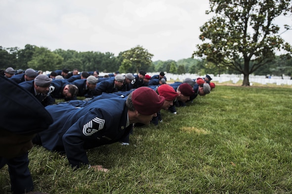Airmen perform memorial pushups following Lt. Col. William “Bill” Schroeder’s interment ceremony June 16, 2016, at Arlington National Cemetery, Va. Schroeder, 39, was a special operations weather officer who identified a perilous situation and reacted swiftly by putting himself between an armed individual and his first sergeant. In the process, he saved lives of other squadron members while being fatally wounded. (U.S. Air Force photo/Airman 1st Class Philip Bryant)