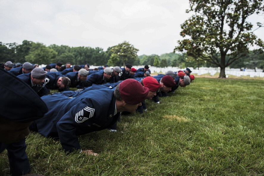 Airmen perform memorial pushups following Lt. Col. William “Bill” Schroeder’s interment ceremony June 16, 2016, at Arlington National Cemetery, Va. Schroeder, 39, was a special operations weather officer who identified a perilous situation and reacted swiftly by putting himself between an armed individual and his first sergeant. In the process, he saved lives of other squadron members while being fatally wounded. (U.S. Air Force photo/Airman 1st Class Philip Bryant)