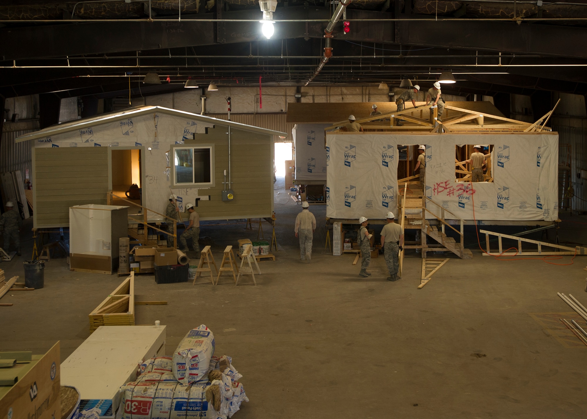 Citizen Airmen from the 446th Civil Engineer Squadron and Seabee’s from the Naval Mobile Construction Battalion 22 construct houses in a warehouse in Gallup, NM, June 13, 2016. Reservists and Seabee’s participated in Operation Footprint, a partnership of the Southwest Indian Foundation and the Department of Defense’s Innovative Readiness Training program, which provides an avenue for training military members. The two-week training allowed joint service members to build homes, which will be given to tribal members of the Navajo Nation who are in need. (U.S. Air Force Reserve photo by Tech. Sgt. Bryan Hull)