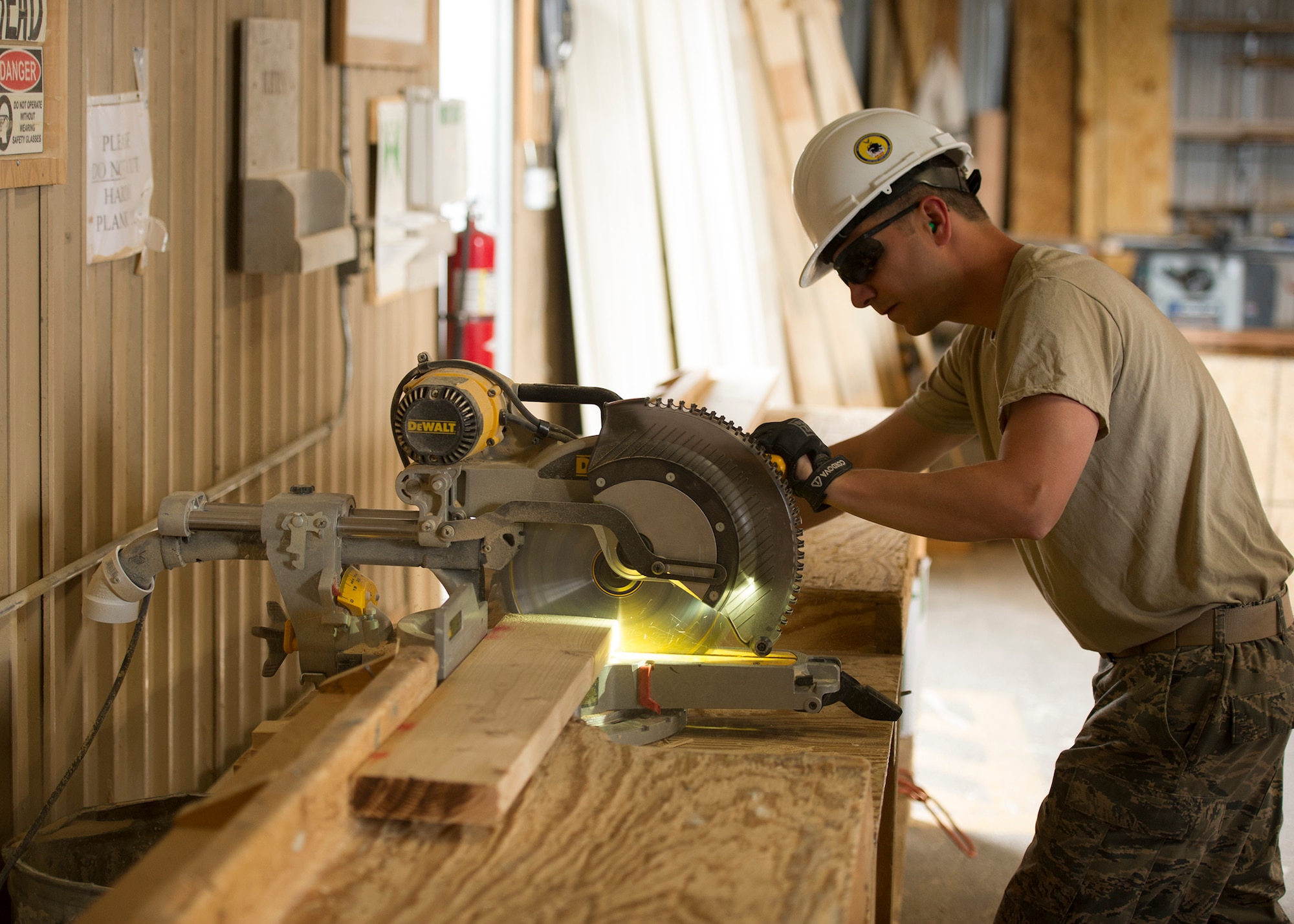 Staff Sgt. John Gibson, 446th Civil Engineer Squadron structures technician, cuts a piece of wood to the proper length for a house under construction in Gallup, NM, June 13, 2016. Rainier Wing Citizen Airmen participated in Operation Footprint, a partnership of the Southwest Indian Foundation and the Department of Defense’s Innovative Readiness Training program, which provides an avenue for training military members. The two-week training allowed Citizen Airmen to construct homes, which will be given to tribal members of the Navajo Nation who are in need. (U.S. Air Force Reserve photo by Tech. Sgt. Bryan Hull)