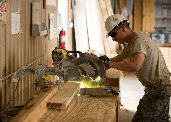 Staff Sgt. John Gibson, 446th Civil Engineer Squadron structures technician, cuts a piece of wood to the proper length for a house under construction in Gallup, NM, June 13, 2016. Rainier Wing Citizen Airmen participated in Operation Footprint, a partnership of the Southwest Indian Foundation and the Department of Defense’s Innovative Readiness Training program, which provides an avenue for training military members. The two-week training allowed Citizen Airmen to construct homes, which will be given to tribal members of the Navajo Nation who are in need. (U.S. Air Force Reserve photo by Tech. Sgt. Bryan Hull)