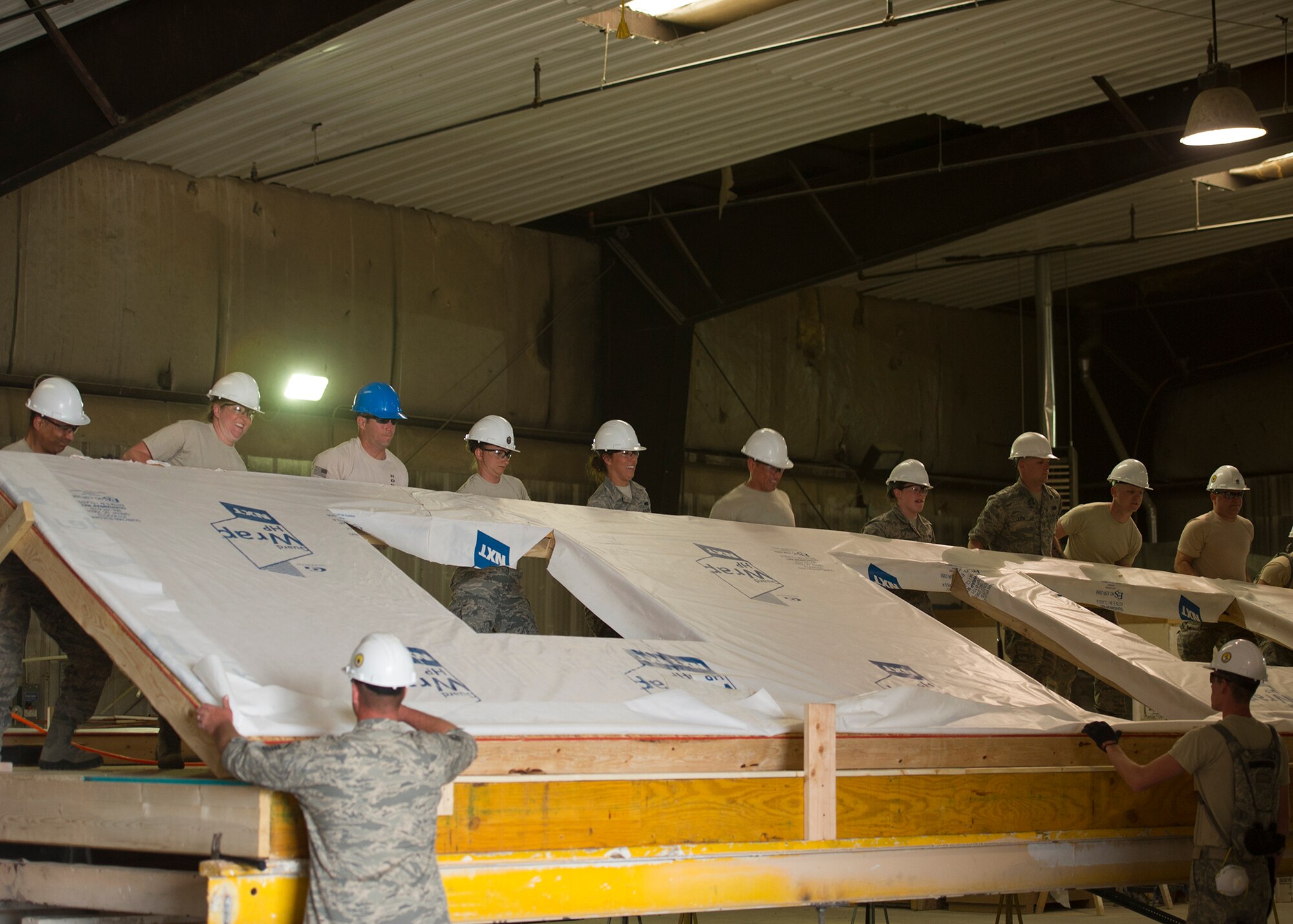 Citizen Airmen from the 446th Civil Engineer Squadron raise the wall of a house under construction in Gallup, NM, June 13, 2016. Reservists participated in Operation Footprint, a partnership of the Southwest Indian Foundation and the Department of Defense’s Innovative Readiness Training program, which provides an avenue for training military members. The two-week training allowed Reservists to construct homes, which will be given to tribal members of the Navajo Nation who are in need. (U.S. Air Force Reserve photo by Tech. Sgt. Bryan Hull)