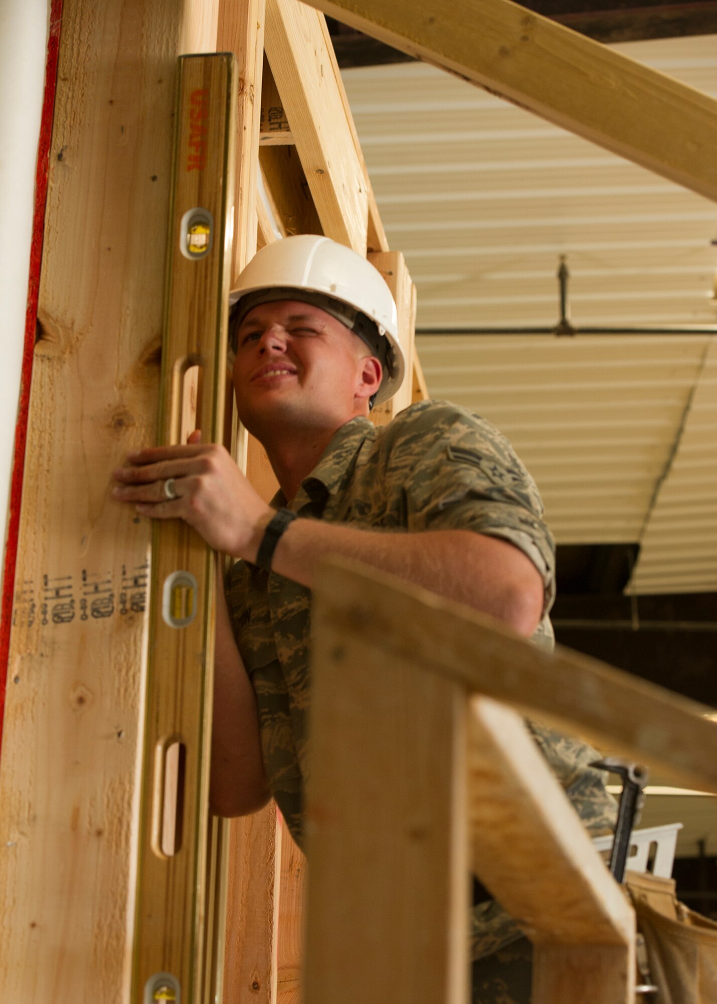 Airman 1st Class Rick Lyons, a utilities technician assigned to the 446th Civil Engineer Squadron, ensures that a wall of a house under construction is straight in Gallup, NM, June 13, 2016. Rainier Wing Citizen Airmen participated in Operation Footprint, a partnership of the Southwest Indian Foundation and the Department of Defense’s Innovative Readiness Training program, which provides an avenue for training military members. Airmen teamed up with Seabee’s from the Naval Mobilization Construction Battalion 22 to construct homes during their two weeks of annual training. (U.S. Air Force Reserve photo by Tech. Sgt. Bryan Hull)