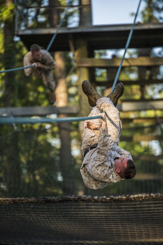 Marines slide down a rope obstacle during a confidence course in Marine Corps Recruit Depot Parris Island during a physical training event June 9. The Provost Marshal’s Office coordinated the event to challenge the Marines physically, build camaraderie and promote teamwork. Marines from every section of PMO participated in the event. The Marines are with PMO, Marine Corps Air Station Beaufort.
