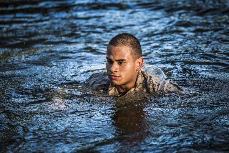 A Marine swims out of the water after falling from a rope obstacle at a confidence course in Marine Corps Recruit Depot Parris Island during a physical training event June 9. The Provost Marshal’s Office coordinated the event to challenge the Marines physically, build camaraderie and promote teamwork. Marines from every section of PMO participated in the event. The Marine is with PMO, Marine Corps Air Station Beaufort.