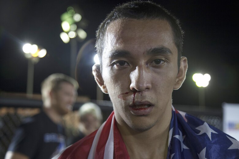 Matt Padilla, an amateur fighter from Temecula, Calif., steps out of the ring after his fight during the Mixed Marital Arts Fight Night Live at Del Valle Field aboard the Marine Corps Air Ground Combat Center, Twentynine Palms, Calif., June 10, 2016. (Official Marine Corps photo by Lance Cpl. Devin Andrews/Released)