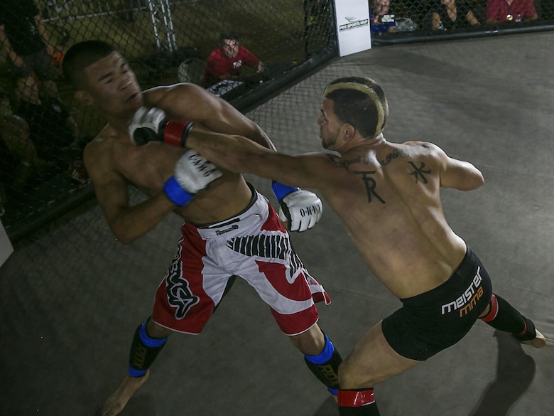 Chris Elisarraras, an amateur fighter from Templeton, Calif., strikes his opponent with a left jab during the Mixed Marital Arts Fight Night Live at Del Valle Field aboard the Marine Corps Air Ground Combat Center, Twentynine Palms, Calif., June 10, 2016.  (U.S. Marine Corps photo by Lance Cpl. Devin Andrews/Released)