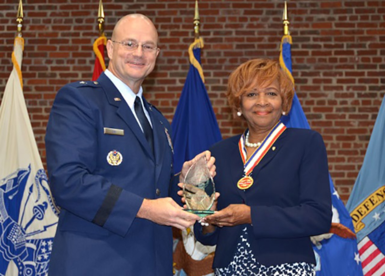 Mary Studevant, Defense Logistics Agency Aviation’s 34th Hall of Fame recipient, receives award from DLA Aviation Commander Brig. Gen. Allan Day, during an induction ceremony June 16, 2016 at the Lotts Conference Center on Defense Supply Center Richmond, Virginia. 