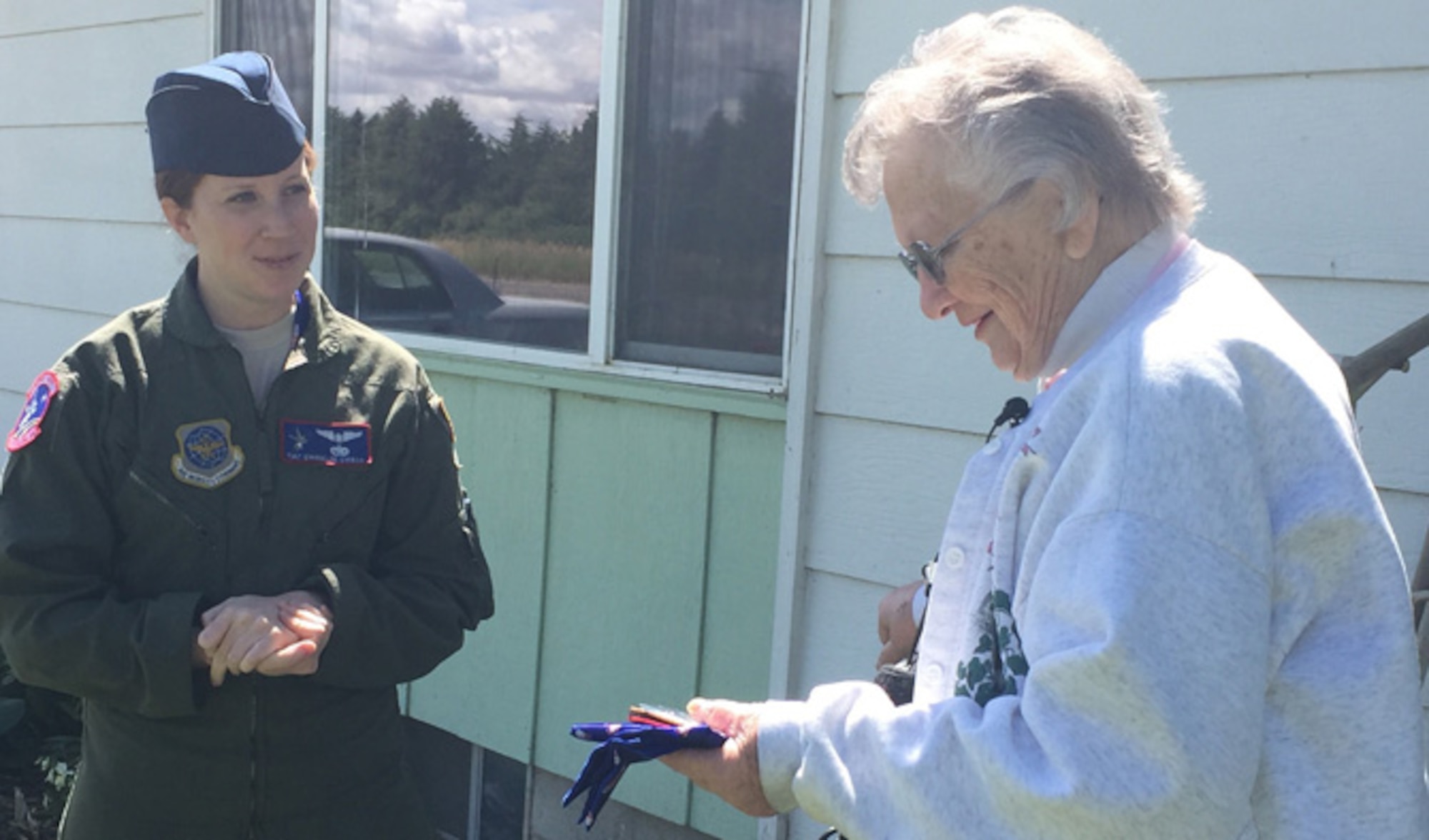 Tech. Sgt. Evangeline Evanzia, 93rd Air Refueling Squadron instructor boom operator, surprised Warden, Wash. native, Pat Rogers, to thank her for her contributions to the Treats 2 Troops program. While deployed, Evanzia received multiple hats from Pat and to this day and continues to wear them throughout the winter months. (U.S. Air Force photo/Airman 1st Class Mackenzie Richardson)