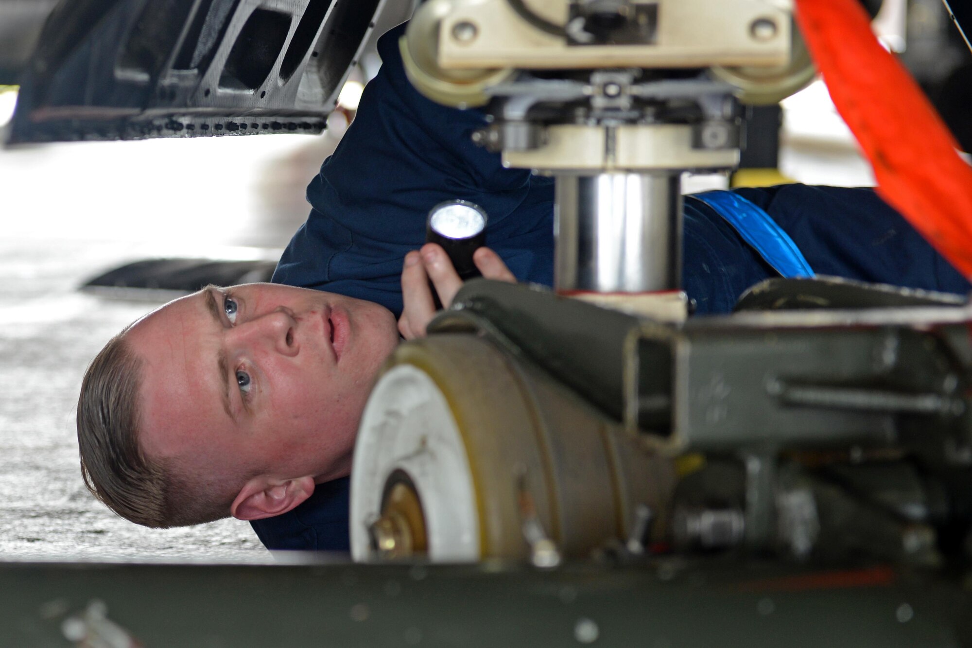 Senior Airman Ryan Turnbull, 9th Aircraft Maintenance Squadron U-2 Dragon Lady dedicated crew chief, performs a post-flight inspection of a U-2's rear landing gear June 7, 2016, at Royal Air Force Fairford, Gloucestershire, England. Turnbull was a member of Beale's en route recovery team (ERT), at RAF Fairford, which transitions aircraft from and to Beale Air Force Base, California, and forward operating locations (FOL). The ERT is used like a pit crew at the midway point in Fairford, ensuring the aircraft are prepared to make it to their next destination. (U.S. Air Force photo by Senior Airman Ramon A. Adelan)