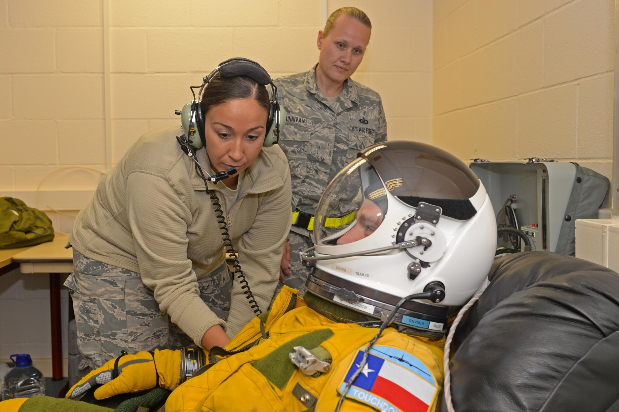 Staff Sgt. Julie Orellana (left), 9th Physiology Support Squadron launch and recovery technician, conducts a pre-flight inspection of a full-pressure suit June 9, 2016, at Royal Air Force Fairford, Gloucestershire, England. The suit allows U-2 pilots to safely fly at altitudes reaching 70,000 feet. (U.S. Air Force photo by Senior Airman Ramon A. Adelan)