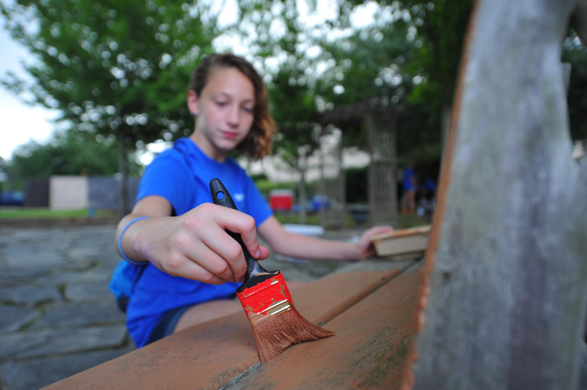 A child with Hurlburt Field’s Special Operations Youth Group paints a bench outside of the library at Hurlburt Field, Fla., June 16, 2016. The youth group raised a $15,000 budget, which funded a wide range of projects, both on- and off-base. (U.S. Air Force photo by Airman 1st Class Joseph Pick)