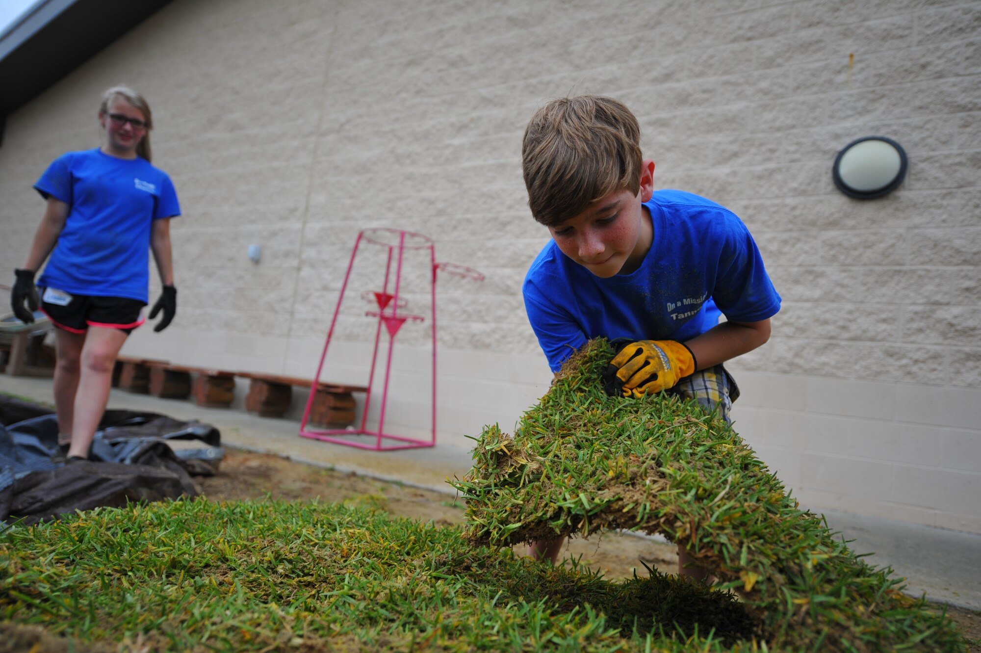 A child with Hurlburt Field’s Special Operations Youth Group grabs a block of sod outside the Child Development Center East at Hurlburt Field, Fla., June 16, 2016. The youth group raised a $15,000 budget, which funded a wide range of projects, both on- and off-base. (U.S. Air Force photo by Airman 1st Class Joseph Pick)