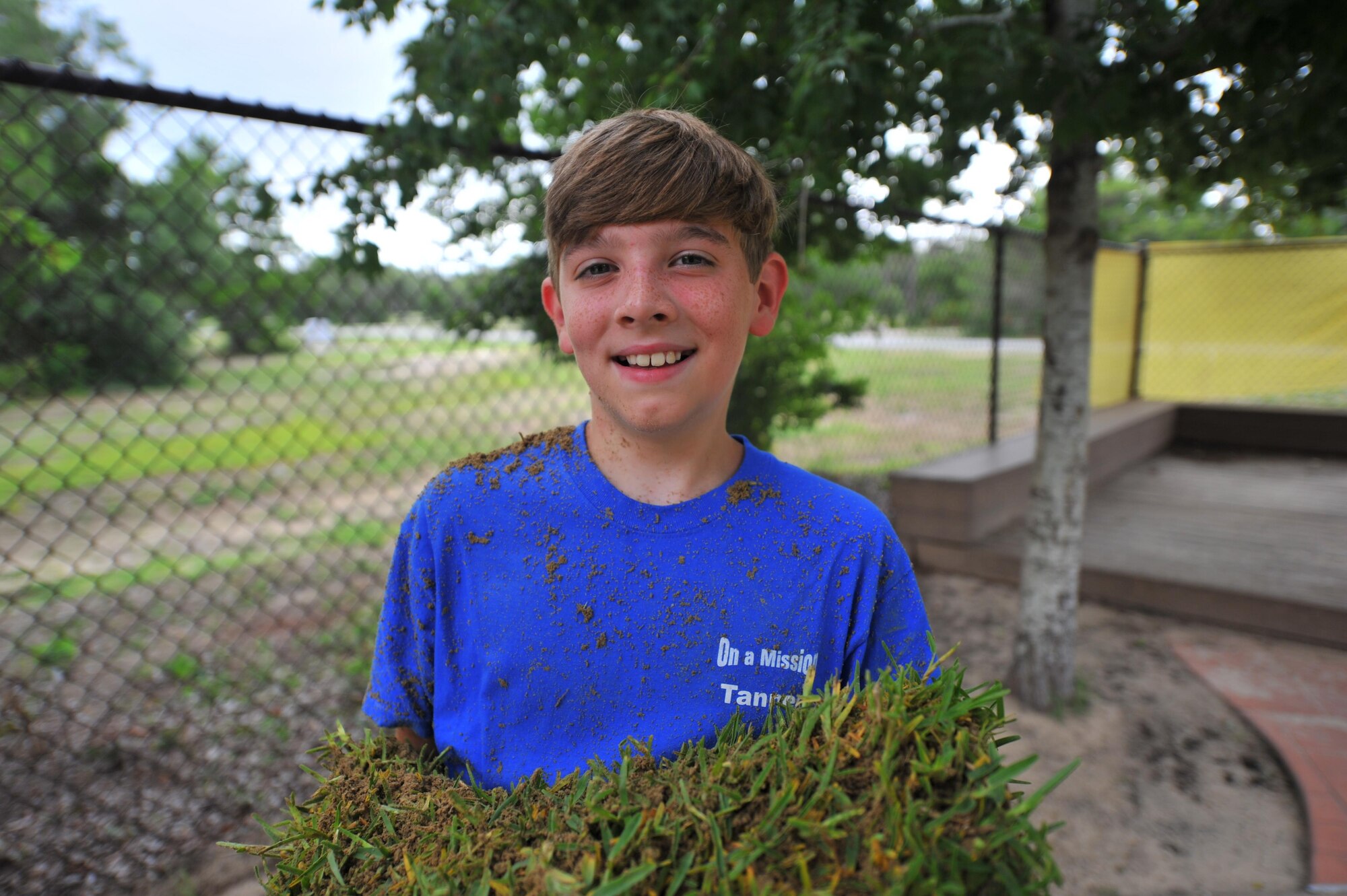A child with Hurlburt Field’s Special Operations Youth Group carries sod outside the Child Development Center East at Hurlburt Field, Fla., June 16, 2016. The youth group’s funding and manpower helped organizations who have challenges in these areas due to fiscal restraints and declining budgets. (U.S. Air Force photo by Airman 1st Class Joseph Pick)