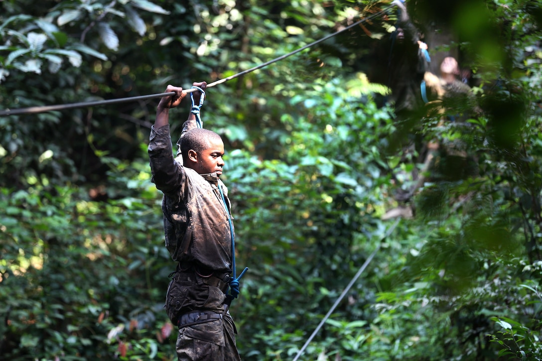 A soldier crosses a rope bride obstacle at the French jungle warfare school in Gabon, June 7, 2016. Army photo by Sgt. Henrique Luiz de Holleben