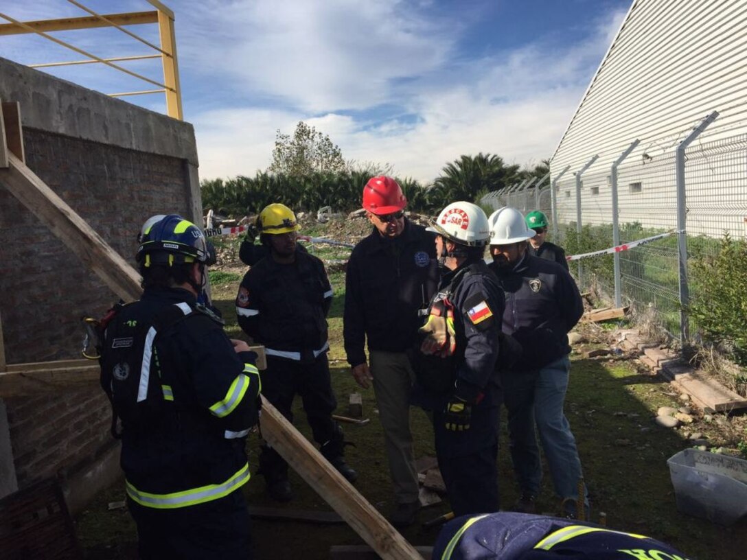 Mr. Tom Niedernhofer, in the red hard hat, was part of a team from USACE that conducted an information exchange with the Chilean army on the Urban Search and Rescue program. The USACE team also featured COL Eric McFadden Mr. Doug Wesemann and Mr. Jarrod Milligan, while the Chilean team included 30 members of the Chilean Army.  Key members present included LTG Luis Farias, the Land Forces Commander and MG Andres Silva, the Engineer Public Works Commander as well two Regional Commanders.  