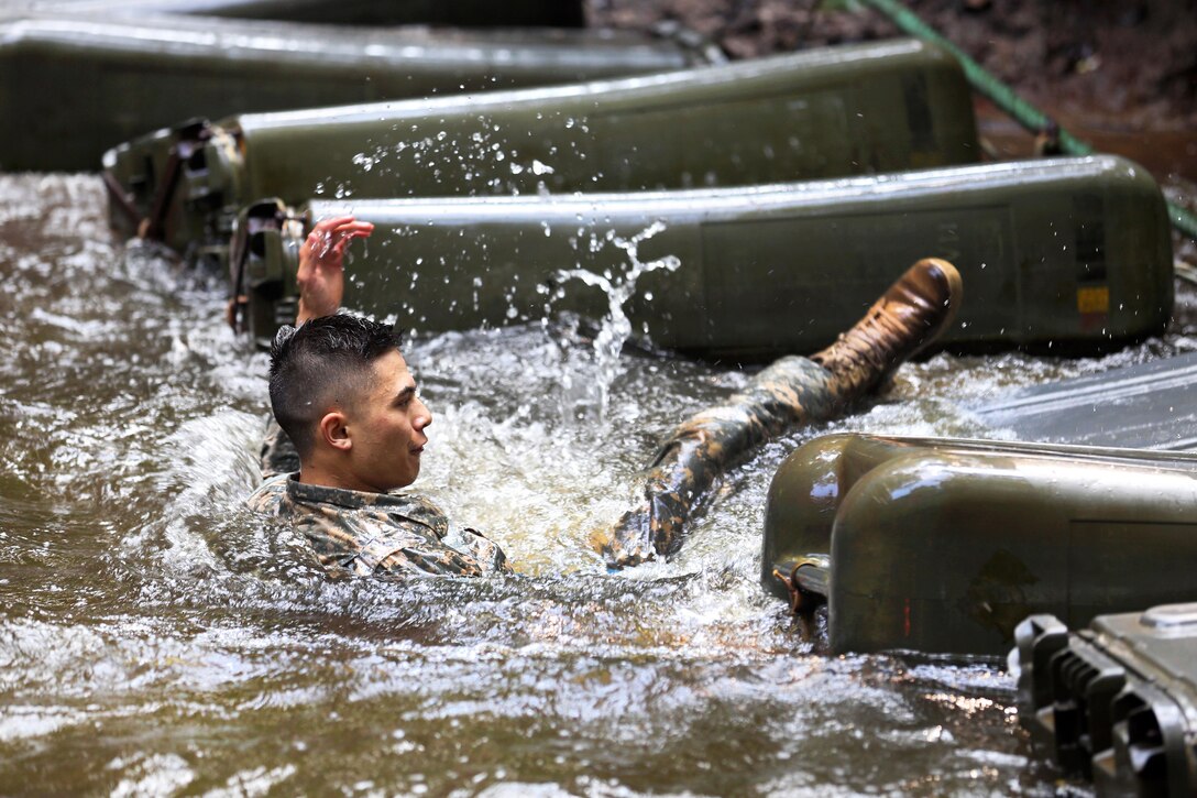 A soldier falls into the water at the French jungle warfare school in Gabon, June 7, 2016. Army photo by Sgt. Henrique Luiz de Holleben