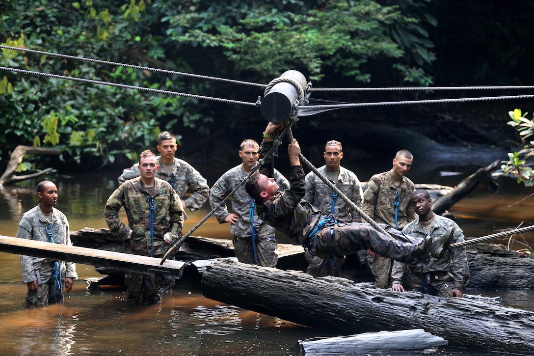 A French army soldier demonstrates how to negotiate a water obstacle to U.S. soldiers at the French jungle warfare school in Gabon, June 7, 2016. Army photo by Sgt. Henrique Luiz de Holleben