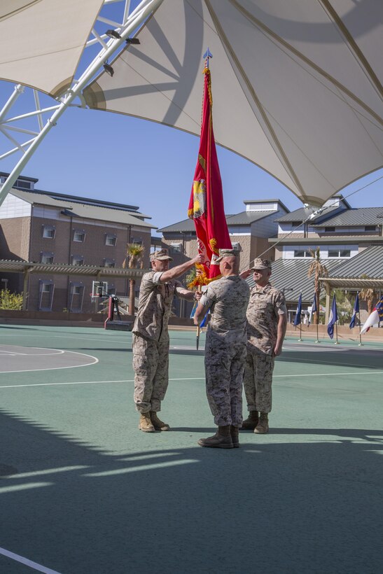 Col. Mathew Cook, off-going commanding officer, and Col. Jason Beaudoin, oncoming commanding officer, Marine Corps Logistics and Operations Group, exchange the unit’s guidon during its change of command ceremony at the Dunham Amphitheater aboard the Marine Corps Air Ground Combat Center, Twentynine Palms, Calif., June 13, 2016. During the ceremony, Cook relinquished command of MCLOG to Beaudoin. (Official Marine Corps photo by Lance Cpl. Alysa Jesse/Released)