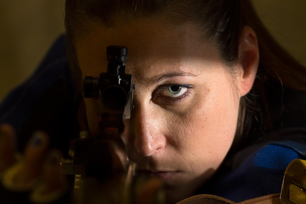 Navy Chief Petty Officer Jeannette Tarqueno poses for a photo with the air rifle she’ll use during competition at the 2016 Department of Defense Warrior Games at the U.S. Military Academy in West Point, N.Y., June 16, 2016. DoD photo by EJ Hersom