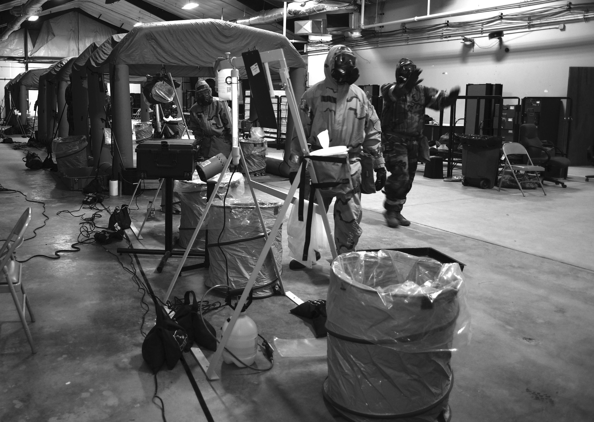 A team of aircrew flight equipment specialists prepare a contamination control area June 9 during the final phase of an Air Staff-sponsored exercise at Hurlburt Field, Fla. They rehearsed the actions and techniques of protecting aircrews from incapacitating contamination when operating in a chemical, biological, radiological and nuclear (CBRN) combat environment. (U.S. Air Force photo / Staff Sgt. Melanie Holochwost)