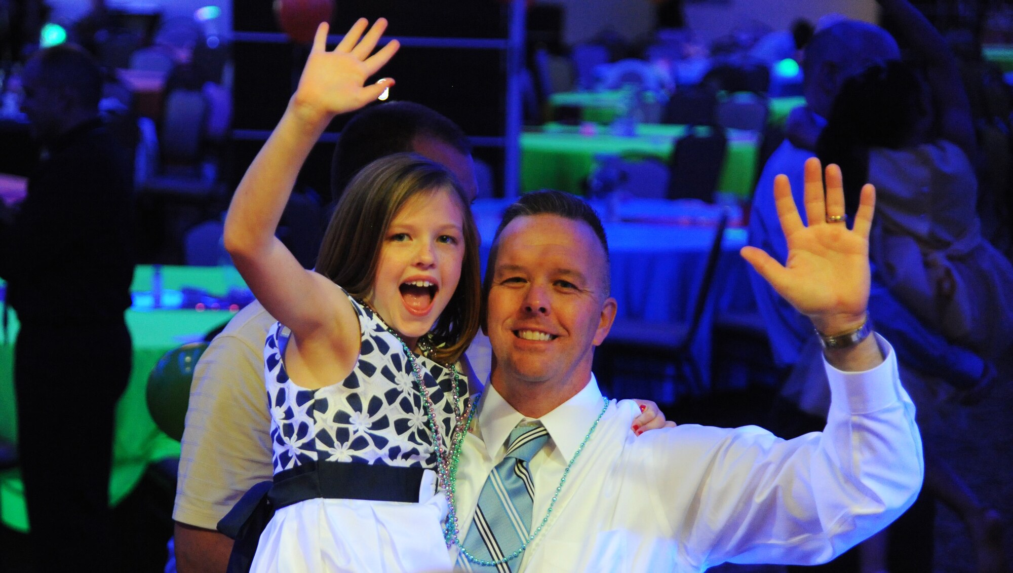 Maj. William Brown, head chaplain assigned to the 927th Air Refueling Wing, and his daughter Sophia, wave during the Daddy/Child dance on MacDill Air Force Base, Fla., June 11, 2016. The dance brought together fathers and their children from throughout MacDill to enjoy food, music and games in celebration of Father’s Day. (U.S. Air Force photo by Airman Adam R. Shanks)