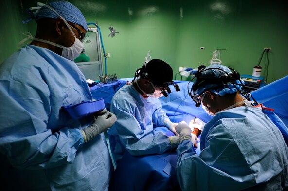 (l-r) Master Sgt. Shawn Elmandorf, orthopedic technician, Lt. Col Evan Jones, orthopedic doctor and Capt. Michael Hawkinson, orthopedic resident, perform a bi-lateral carpal tunnel release surgery June 8, at Rio San Juan hospital, Dominican Republic, during a Medical Readiness Training Exercise or MEDRETE as part of NEW HORIZONS 2016.  The MEDRETE is an exercise where U.S. military doctors and technicians partnered with medical professionals from the Dominican Republic, and practiced their craft in an expeditionary environment. Elmandorf and Hawkinson are deployed from the 59th Medical Wing, Joint Base San Antonio, Texas.(U.S. Air Force photo by Master Sgt. Chenzira Mallory/released)