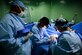 Master Sgt. Shawn Elmandorf, left, an orthopedic technician; Lt. Col. Evan Jones, an orthopedic doctor; and Capt. Michael Hawkinson, an orthopedic resident, perform a bilateral carpal tunnel release surgery June 8, 2016, at Rio San Juan hospital, Dominican Republic, during medical readiness training as part of exercise New Horizons 2016. The training had U.S. military doctors and technicians partner with Dominican Republic medical professionals as they practiced their craft in an expeditionary environment. Elmandorf and Hawkinson are deployed from the 59th Medical Wing at Joint Base San Antonio, Texas. (U.S. Air Force photo/Master Sgt. Chenzira)
