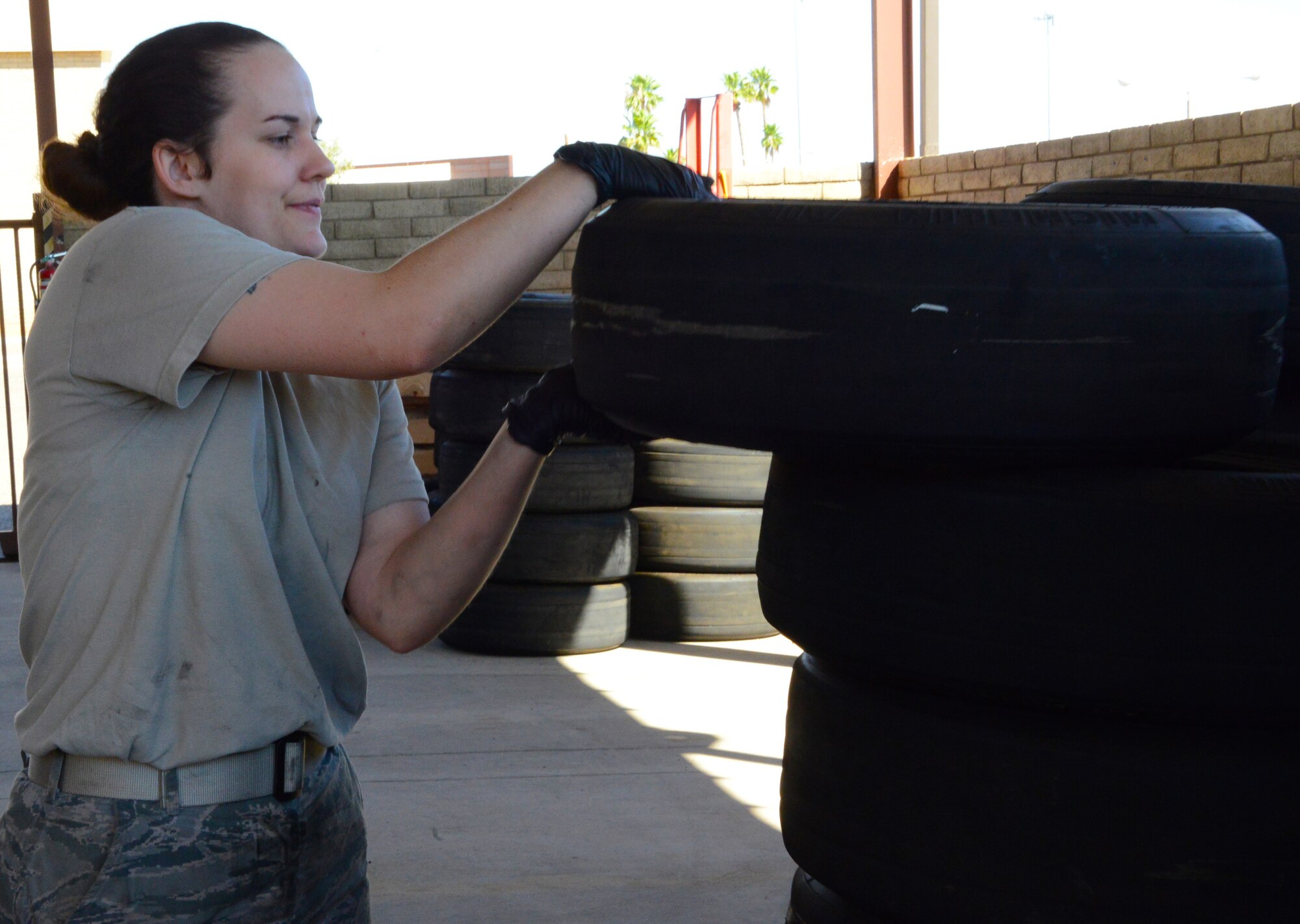 Staff Sgt. Audry Palowski, 56th Equipment Maintenance Squadron wheel and tire team member, stacks a worn wheel for recycling June 15, 2016, at Luke Air Force Base, Ariz. The wheel and tire section is responsible for disassembling, inspecting, repairing, assembling and servicing wheels for 43 F-35 Lightning II aircraft and 71 F-16 Fighting Falcon aircraft. (U.S. Air Force photo by Tech. Sgt. Timothy Boyer)