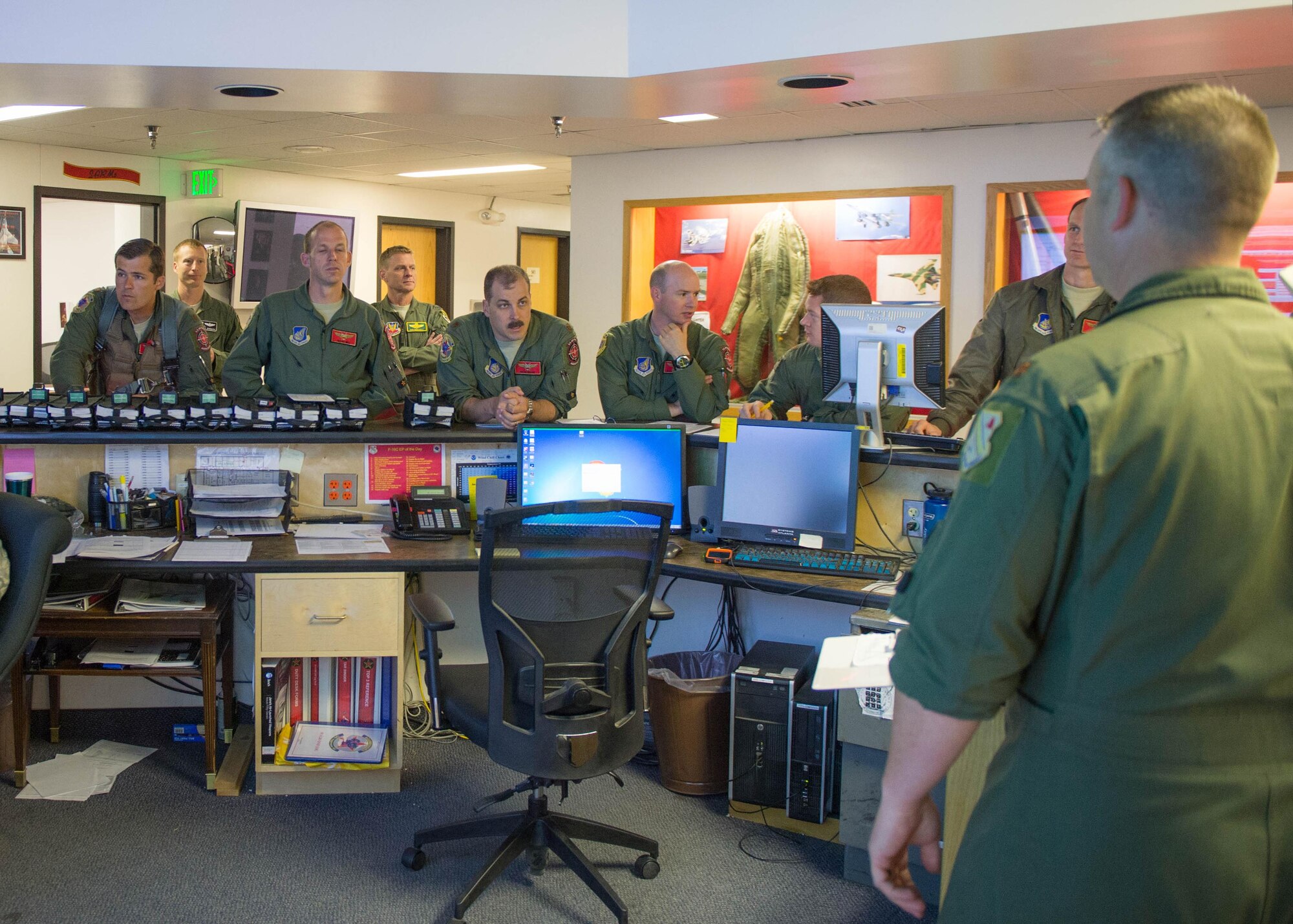 U.S. Air Force fighter pilots with the 18th Aggressor Squadron brief for sortie June 14, 2016, during RED FLAG-Alaska 16-2 at Eielson Air Force Base, Alaska. After every briefing, pilots utter in unison, “Have at you!” taken from the 1975 film “Monty Python and the Holy Grail,” signifying being the enemy squadron who will defend its battlefield regardless of the cost. (U.S. Air Force photo by Staff Sgt. Shawn Nickel/Released)
