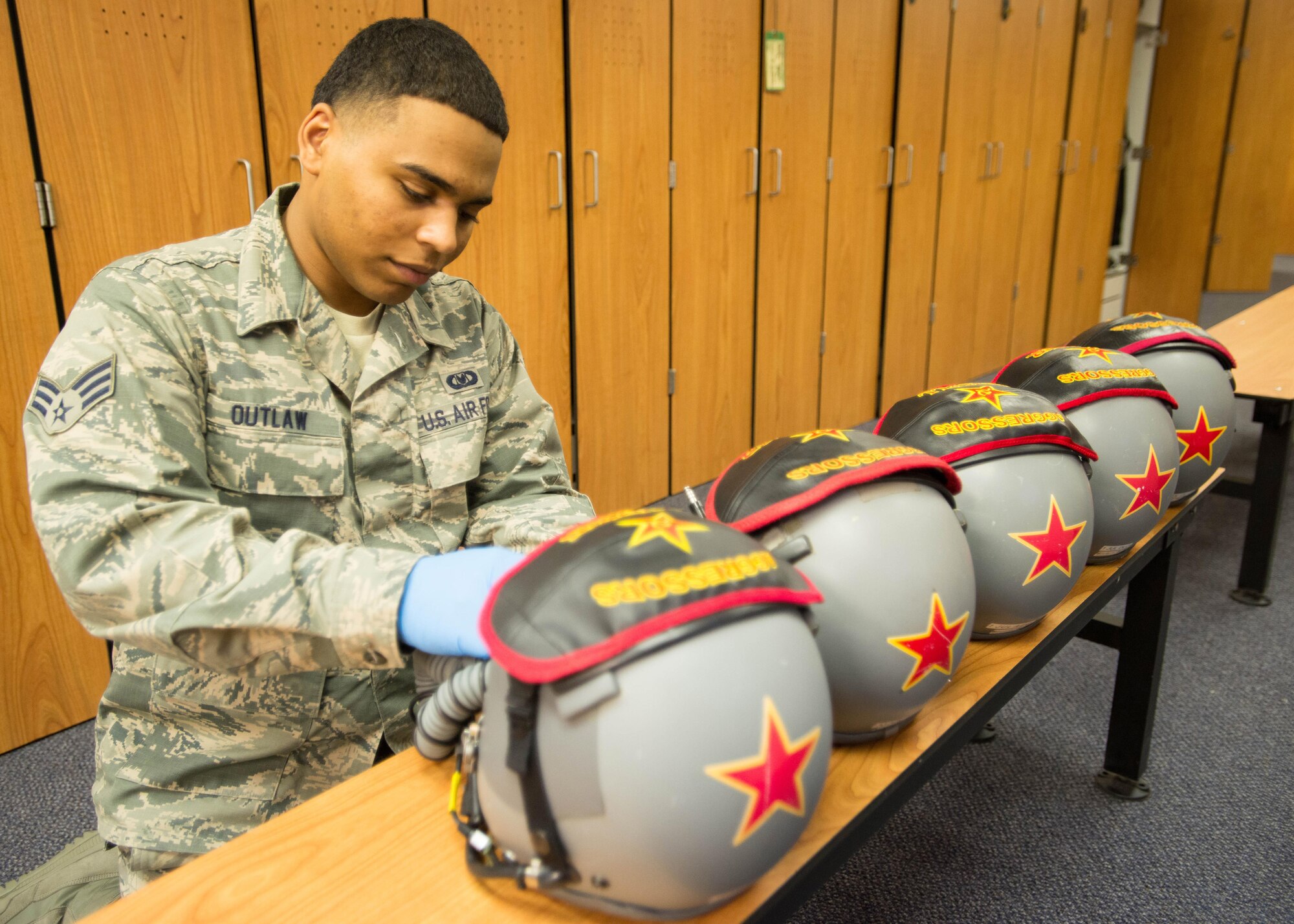 U.S. Air Force Senior Airman Demonte Outlaw, a 354th Operations Support Squadron aircrew flight equipment journeyman, maintains helmets used by pilots with the 18th Aggressor Squadron (AGRS), June 15, 2016, during RED FLAG-Alaska (RF-A) 16-2 at Eielson Air Force Base, Alaska. The 18th AGRS use a red star on their helmets to mark the mission of being experts in enemy tactics in exercises such as RF-A, a U.S. Pacific Air Forces commander-directed exercise, which has helped train more than 150,000 aircrew members for combat in the past 40 years. (U.S. Air Force photo by Staff Sgt. Shawn Nickel/Released)
