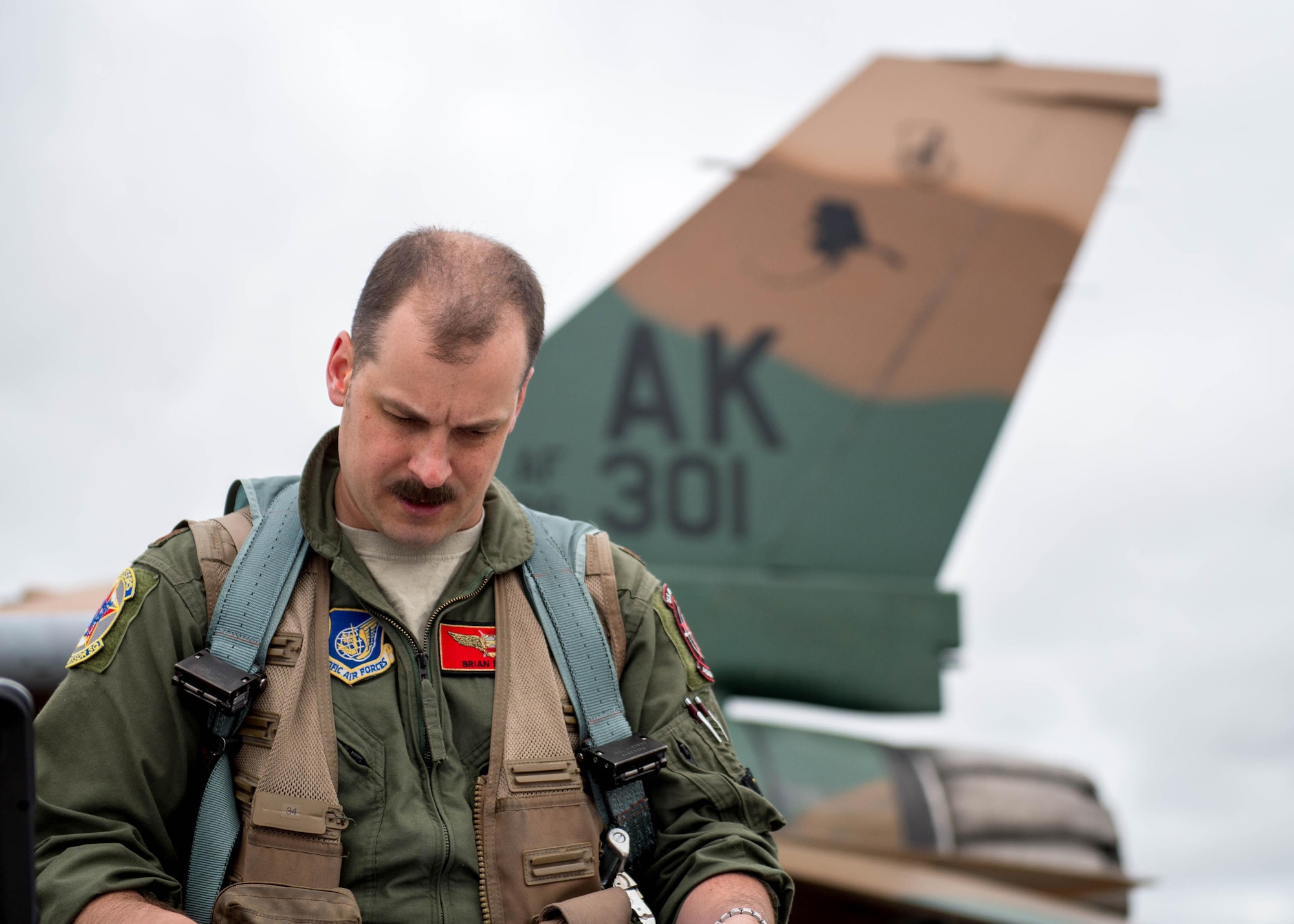 U.S. Air Force Maj. Brian Bragg, the 18th Aggressor Squadron assistant director of operations, reads maintenance continuity reports prior to take off as a “bad guy” for a sortie June 14, 2016, during RED FLAG-Alaska (RF-A) 16-2 at Eielson Air Force Base, Alaska. RF-A, a U.S. Pacific Air Forces commander-directed exercise, has helped train more than 150,000 aircrew members for combat in the past 40 years. (U.S. Air Force photo by Staff Sgt. Shawn Nickel/Released)
