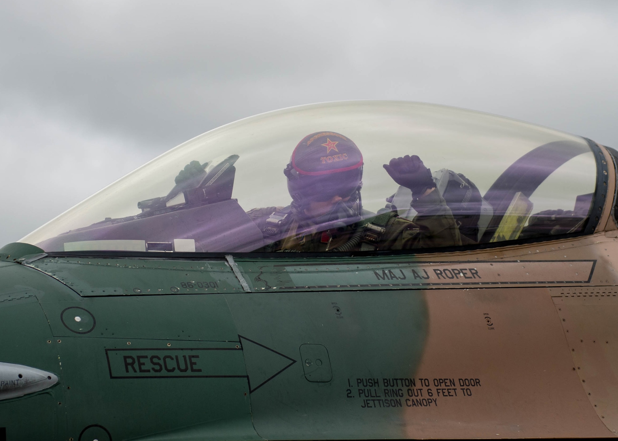 U.S. Air Force Maj. Brian Bragg, the 18th Aggressor Squadron assistant director of operations, uses hand signals to communicate with crew chiefs from the 354th Aircraft Maintenance Squadron while they prepare an F-16 Fighting Falcon fighter aircraft to take off as the “bad guy” for a sortie June 14, 2016, during RED FLAG-Alaska (RF-A) 16-2 at Eielson Air Force Base, Alaska. RF-A exercises keep fighters in the air through 10 simulated combat sorties flying over the Joint Pacific Alaska Range Complex, a more than 67,000 square mile airspace that includes one conventional bombing range and two tactical bombing ranges containing 510 different types of targets and 45 threat simulators. (U.S. Air Force photo by Staff Sgt. Shawn Nickel/Released)
