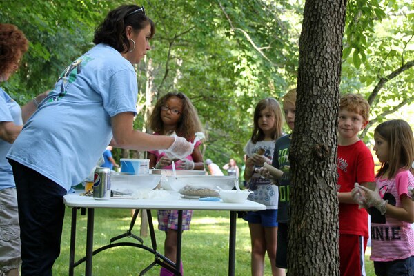 Tammy Wilson with PRIDE demonstrates to the children how to make bird feeders at their station during the Get Outdoors Day activities at the U.S. Army Corps of Engineers Nashville District's Lake Cumberland Natural Resource Manager's Office in Somerset, Ky., June 16, 2016. 