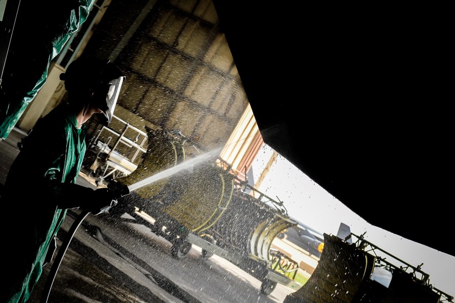 A crew chief from the 2nd Maintenance Squadron rinses a B-52 Stratofortress wing flap during a pre-phase inspection wash at Barksdale Air Force Base, La., June 15, 2016.  Water was sprayed prior to applying soap removing spent fuel byproducts produced by the engines and any grime and dirt stuck to the airframe. (U.S. Air Force photo/Senior Airman Mozer O. Da Cunha)