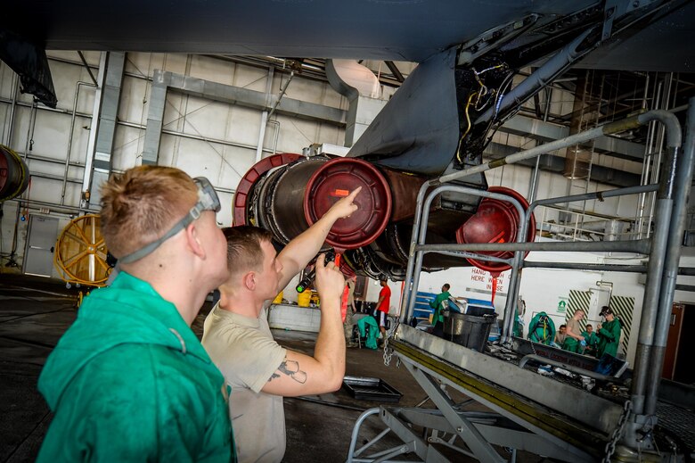 Staff Sgt. Drew Landis, 2nd Maintenance Squadron crew chief and Airman 1st Class Tristan McBurney-Bennett, 2nd Maintenance Squadron crew chief inspect a washed component with Airman 1st Class Tristan McBurney-Bennett, during a pre-phase inspection wash at Barksdale Air Force Base, La., June 15, 2016. Landis performed a pre-inspection of the wash prior to the final quality assurance inspection. (U.S. Air Force photo/Senior Airman Mozer O. Da Cunha)