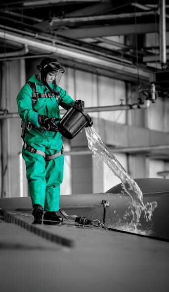 Airman 1st Class Tong Thao, 2nd Maintenance Squadron crew chief, soaks a B-52 Stratofortress wing during a pre-phase inspection wash at Barksdale Air Force Base, La., June 15, 2016. Thao purred water on the wing prior to using a cleaning solution to remove grease, dirt and grime. Cleaning the aircraft prior to a phase inspection facilitates the detection of potential cracks and defects in the airframe (U.S. Air Force photo illustration/Senior Airman Mozer O. Da Cunha) 