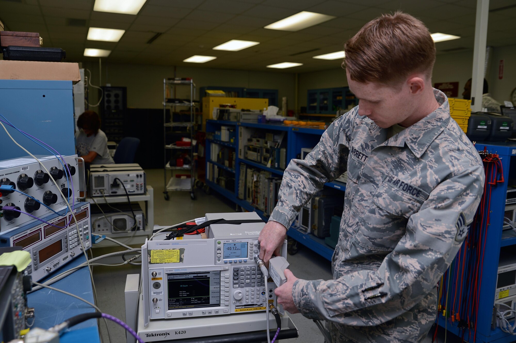 Senior Airman Christopher Barrett, 62nd Maintenance Squadron precision measurement equipment laboratory technician, calibrates a piece of radio equipment using an automation process June 7, 2016 at Joint Base Lewis-McChord, Wash. The PMEL shop has been able to automate equipment through working with manufacturers to develop automation processes. (U.S. Air Force photo/Senior Airman Jacob Jimenez) 