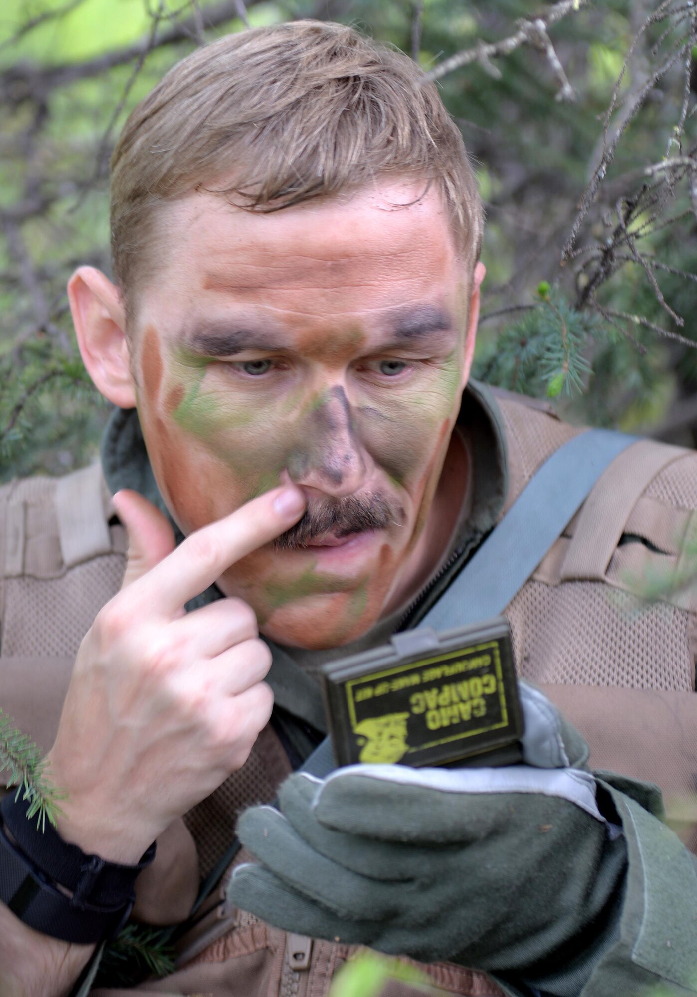 U.S. Air Force Capt. Keli Kaaekuahiwi, an A-10 pilot assigned to the 354th Fighter Squadron out of Davis-Monthan Air Force Base, Ariz., applies face paint while evading capture during a personnel recovery exercise at a training site in the Joint Pacific Alaska Range Complex, June 14, 2016, during RED FLAG-Alaska (RF-A) 16-2. RF-A gives U.S. and partner nation forces an opportunity to sharpen combat skills like search and rescue in a realistic threat environment inside the Joint Pacific Alaska Range Complex, which at more than 67,000 square miles, is the largest instrumented air, ground and electronic combat training range in the world. (U.S. Air Force photo by Master Sgt. Karen J. Tomasik/Released)