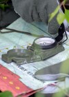 Capt. Keli Kaaekuahiwi, an A-10 pilot assigned to the 354th Fighter Squadron out of Davis-Monthan Air Force Base, Ariz., aligns his compass and map during a personnel recovery exercise at a training site in the Joint Pacific Alaska Range Complex (JPARC), June 14, 2016, during RED FLAG-Alaska (RF-A) 16-2. The JPARC provides a realistic training environment and allows commanders to train for full spectrum engagements, ranging from individual skills, such as isolated personnel evading capture, to complex, large-scale joint engagements. (U.S. Air Force photo by Master Sgt. Karen J. Tomasik/Released)