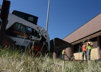 Staff Sgt. Dustin Snyder, 28th Civil Engineer Squadron hazardous material custodian, directs the dumping of the base course, a soil support layer, as part of a renovations project for the Holbrook Library at Ellsworth Air Force Base, S.D., June 16, 2016. In addition to new sidewalks, the library will also be getting a new patio built for its patrons to enjoy during their visits. (U.S. Air Force photo by Senior Airman Anania Tekurio/Released) 
