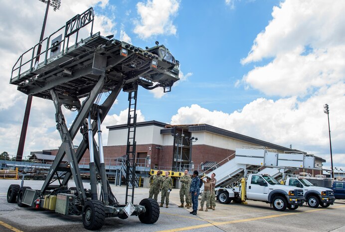 Sailors from Navy Cargo Handling Battalion THIRTEEN watch a demonstration on the proper operation of the 437th Ariel Port Squadron loader vehicle June 10, 2016, at Joint Base Charleston – Air Base, S.C. This training was a part of NCHB13s Exercise Golden Steamboat. This exercise is a high-tempo exercise intended to significantly increase unit readiness and individual qualifications in preparation for the battalion’s Unit Level Training Readiness Assessment 2017, the unit’s large-scale exercise. (U.S. Air Force photo/Senior Airman Clayton Cupit)