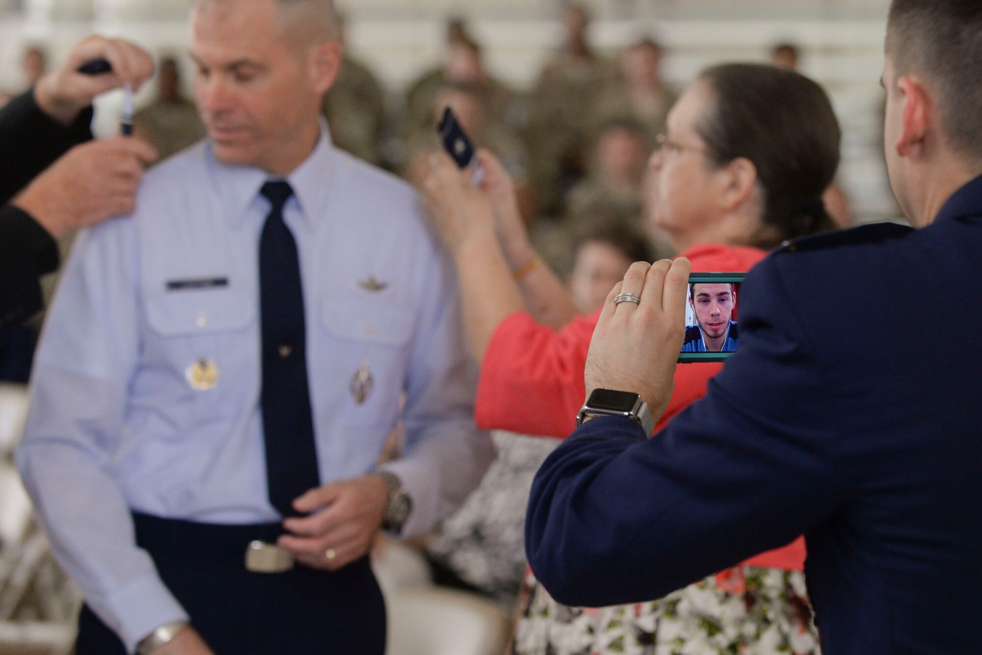 Michael Lutton’s father and mother-in-law place brigadier general rank on his epaulettes during his promotion ceremony at Minot Air Force Base, N.D., June 17, 2016. Lutton’s son Kyle was able to virtually attend the ceremony. (U.S. Air Force photo/Airman 1st Class Jessica Weissman)
