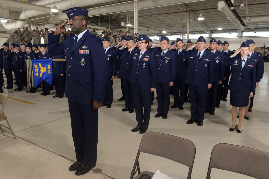 Col. Kelvin Townsend, vice commander of the 91st Missile Wing, and other members of the 91st MW present a first salute to Col. Colin Connor during the 91st MW change of command ceremony June 17, 2016. Connor assumed command of the 91st MW after serving in Washington, D.C., as a Chief of Staff of the Air Force Fellow. (U.S. Air Force photo/Airman 1st Class Jessica Weissman)