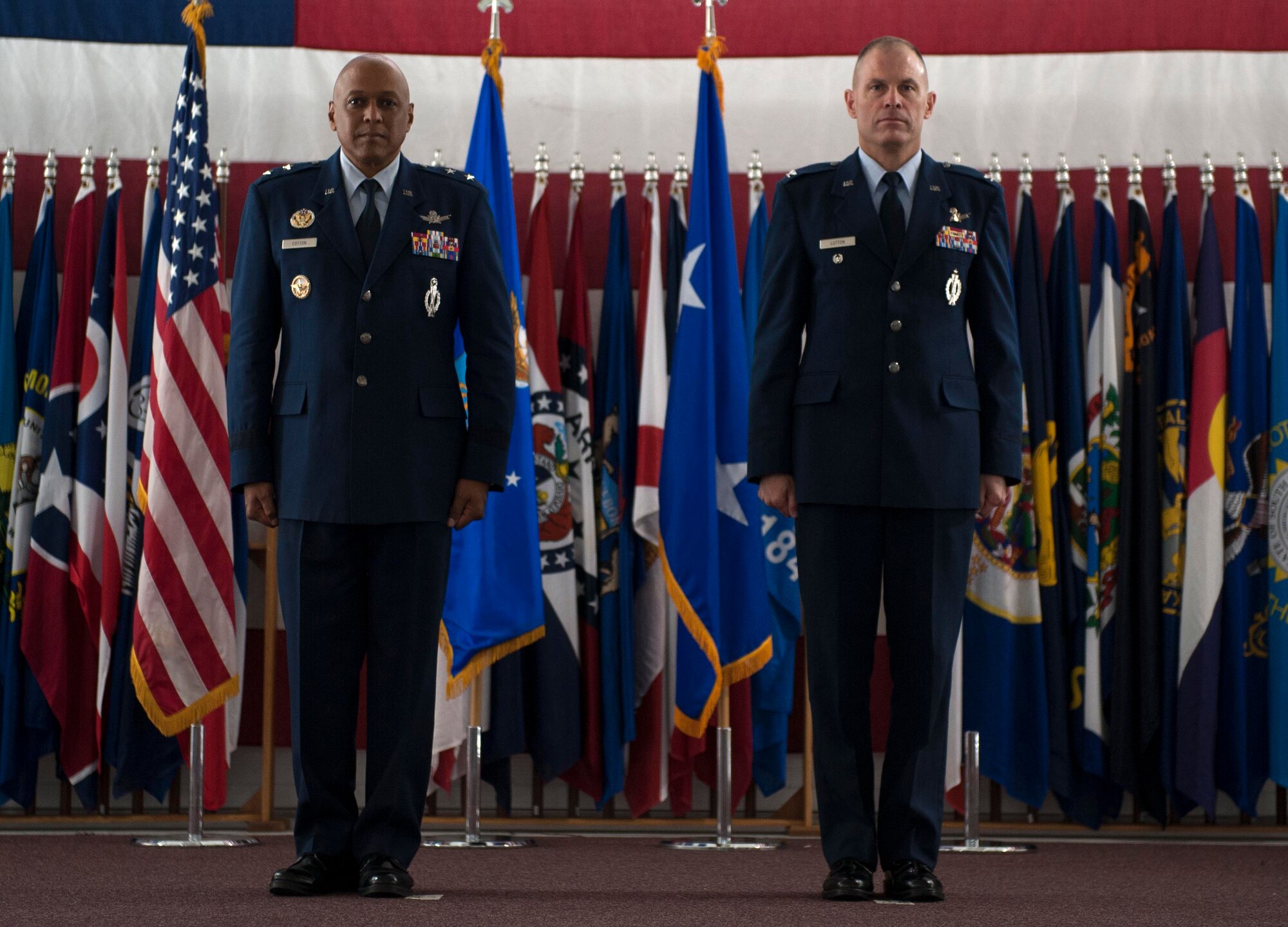 New Brig. Gen. Michael Lutton, who is headed to the Pentagon to work with the Department of Energy, is presented his Brig. Gen. flag by Tech. Sgt. Joshua Hull, non-commissioned officer in charge of Base Honor Guard, at Minot Air Force Base, N.D., June 17, 2016. The presentation of the General flag is an Air Force tradition. (U.S. Air Force photo/Senior Airman Kristoffer Kaubisch) 