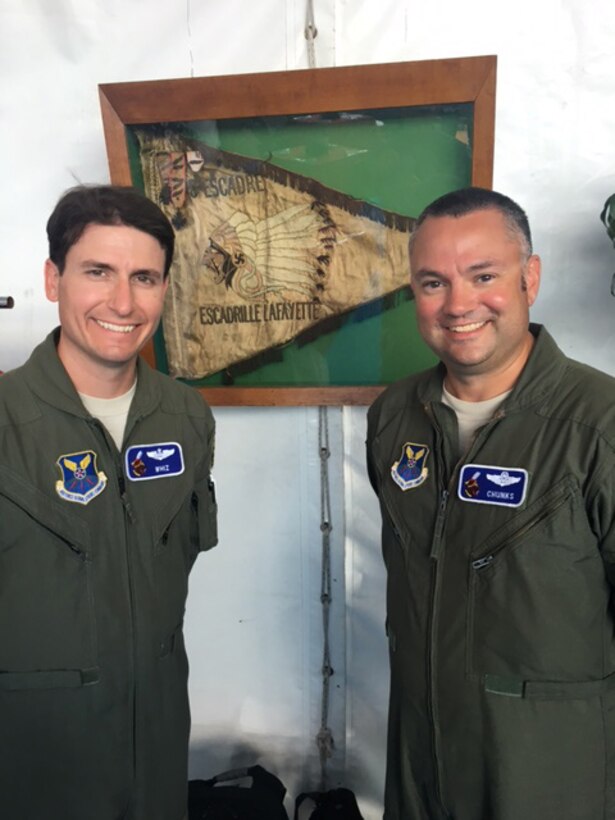 U.S. Air Lt. Cols. ‘Whiz’ and ‘Chunks’, 28th Bomb Squadron instructor aircrew, pose in front of a Lafayette Escadrille flag from World War I June 5, 2016, at Istres-Le Tubé Air Base, France. Dyess Airmen were in attendance for the Istres Air Show, which celebrated 100 years since the Lafayette Escadrille, a unit of American Airmen who volunteered to fight alongside the French in World War I. (Courtesy photo)