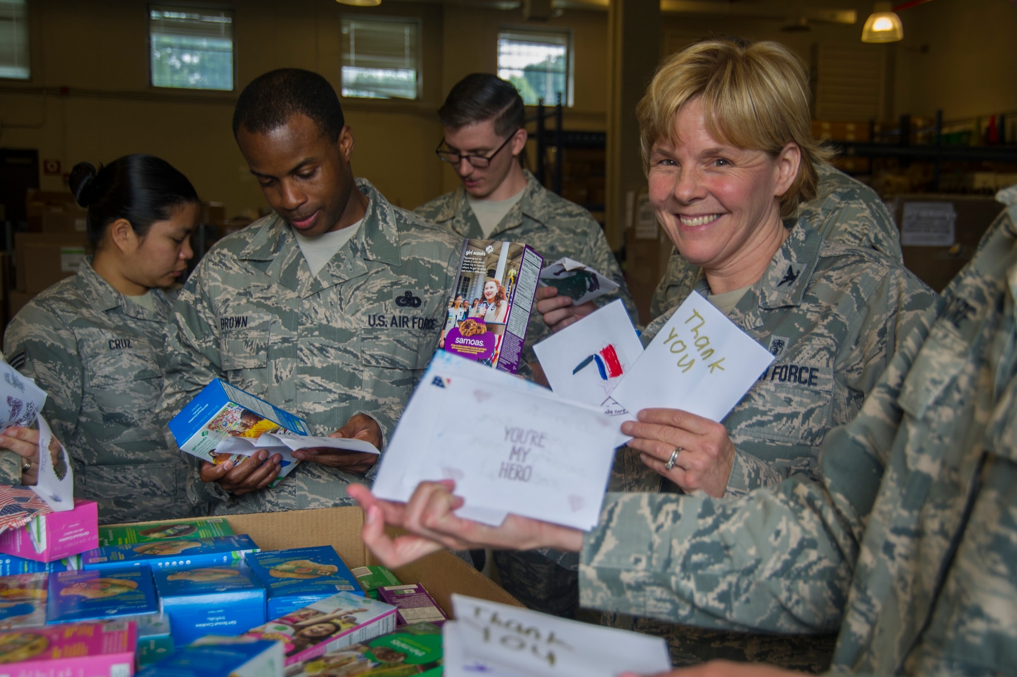 Col. Sharon Bannister, 79th Medical Wing commander, smiles after reading handmade ‘thank you’ notes received in a shipment of Girl Scout Cookies to the MDW on Joint Base Andrews, Md., June 15, 2016. Notes were made by Girl Scout Troops and put in with the boxes of cookies delivered to base. (U.S. Air Force photo by Airman Gabrielle Spalding)